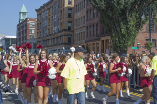 The University of Massachusetts cheerleading team marching in the MGM Springfield grand opening parade