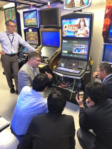 Commissioner Enrique Zuniga, Gaming Technical Compliance Manager Scott Helwig demonstrate PlayMyWay at the MGC Gaming Lab to members of the Resourceful Center for Problem Gambling